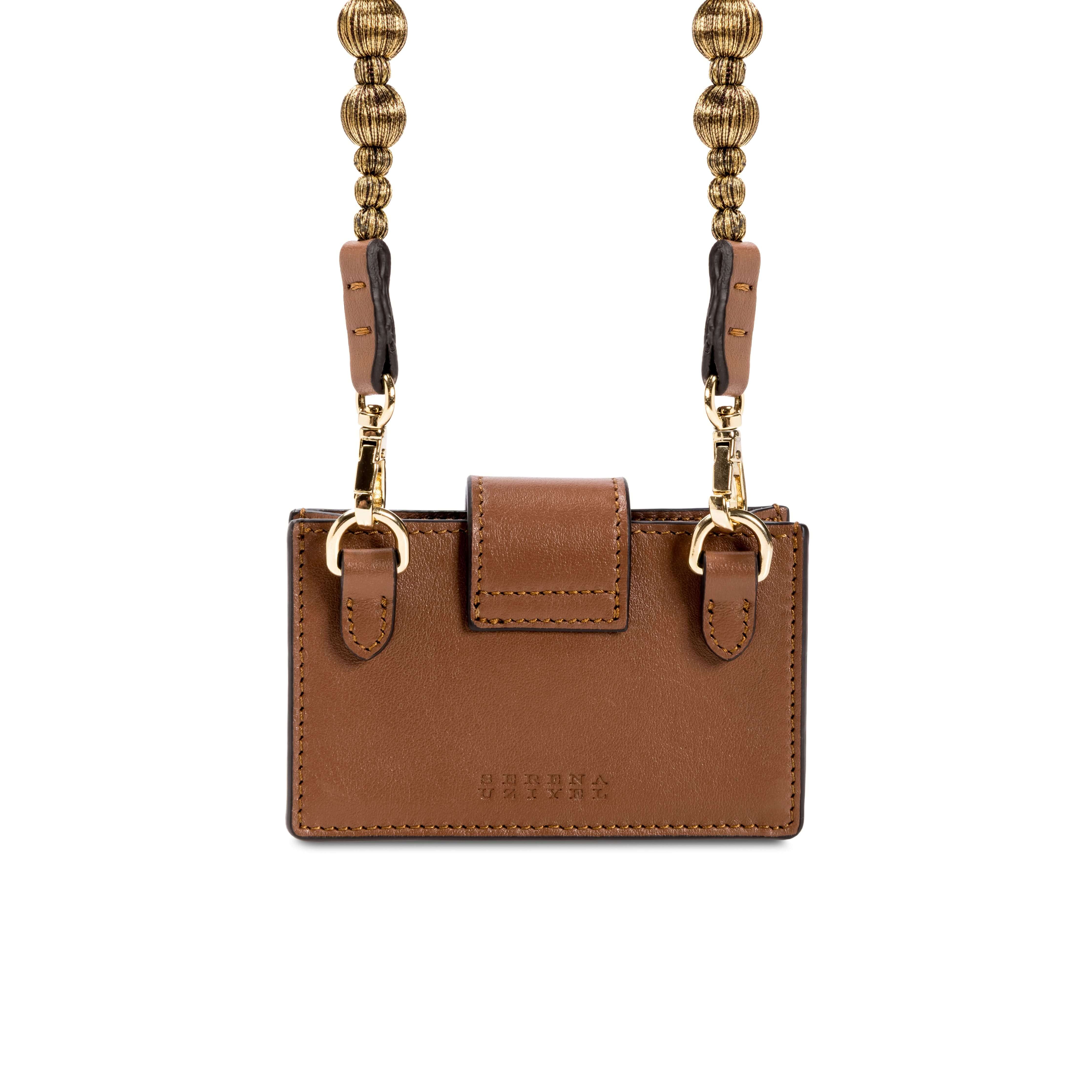 Alessa Camello card holder in brown leather with a detachable strap featuring embroidered balls, showcasing refined craftsmanship.