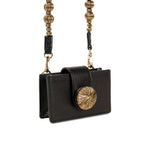 Alessa Black Card Holder with metallic embroidered disc and detachable beaded strap for a chic, sculptural look.