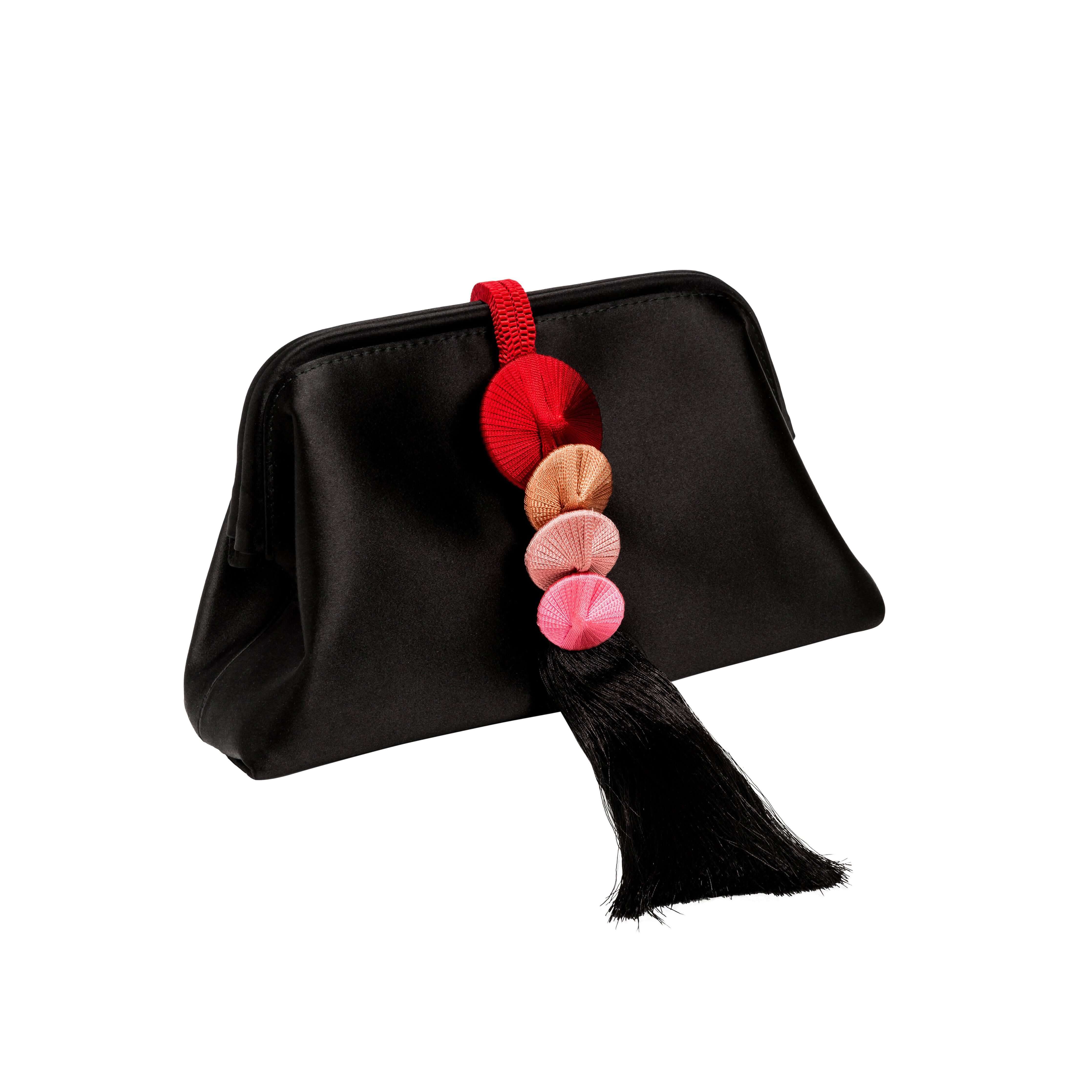 Alessa Black Pouch Bag featuring intricate thread-wrapped coins and a stylish tassel for an elegant touch.