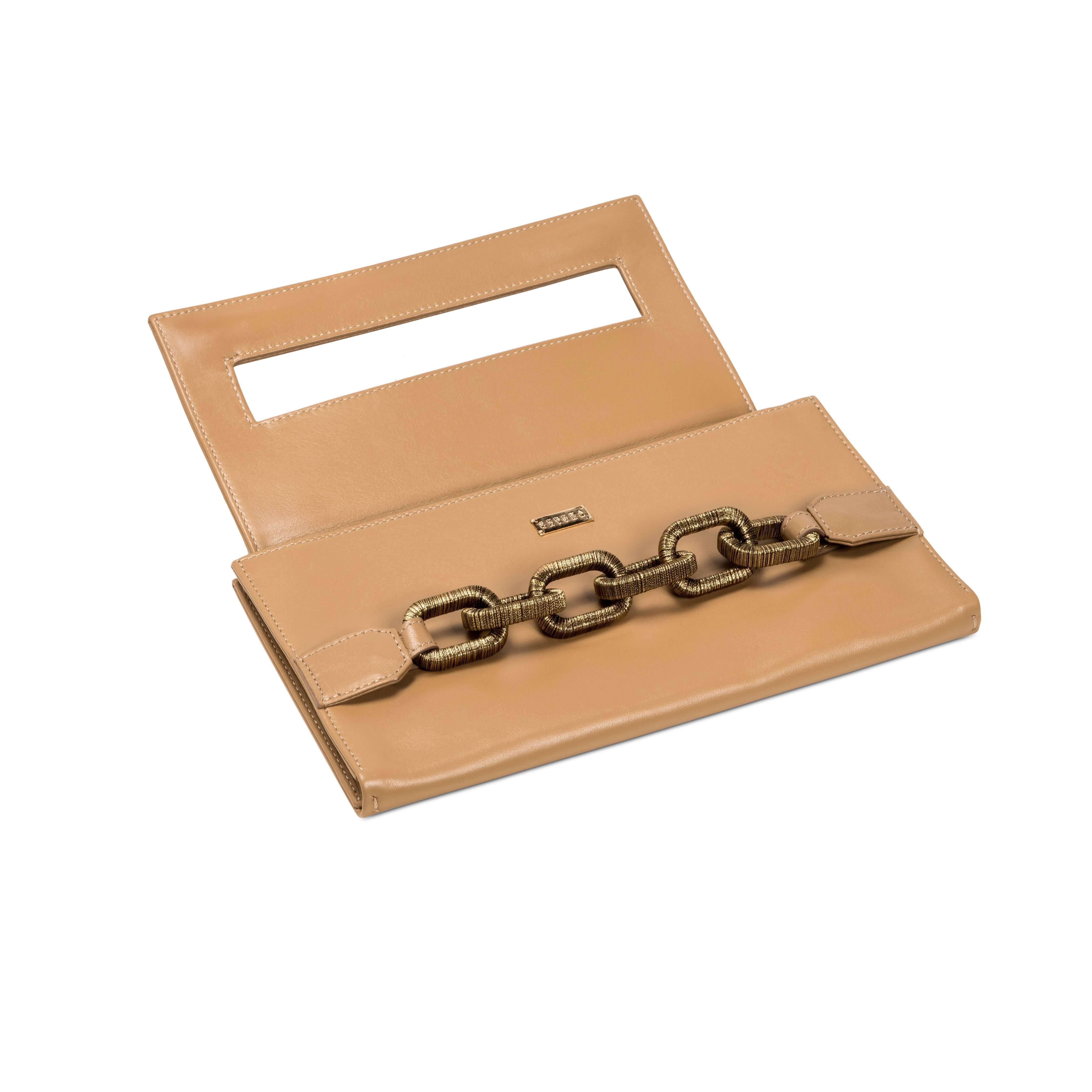 Elegant beige clutch bag featuring a distinctive antique gold chain detail and a cut-out handle design.