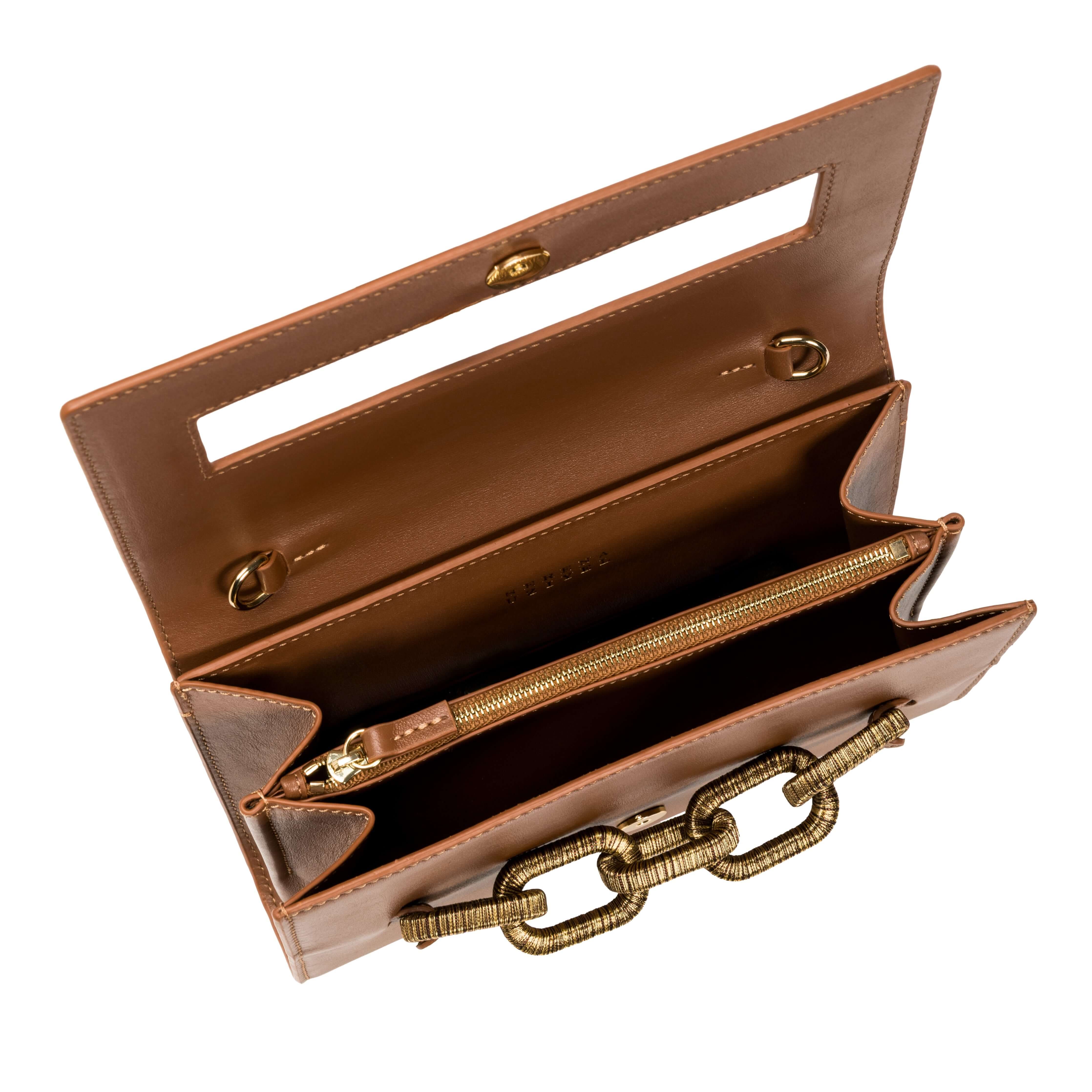 Interior view of Catena Day to Night Camello Bag, showcasing leather compartments and signature chain detail.