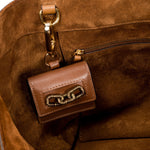 Interior view of Catena Notte Camello handbag showcasing a stylish brown keychain wallet with chain design.