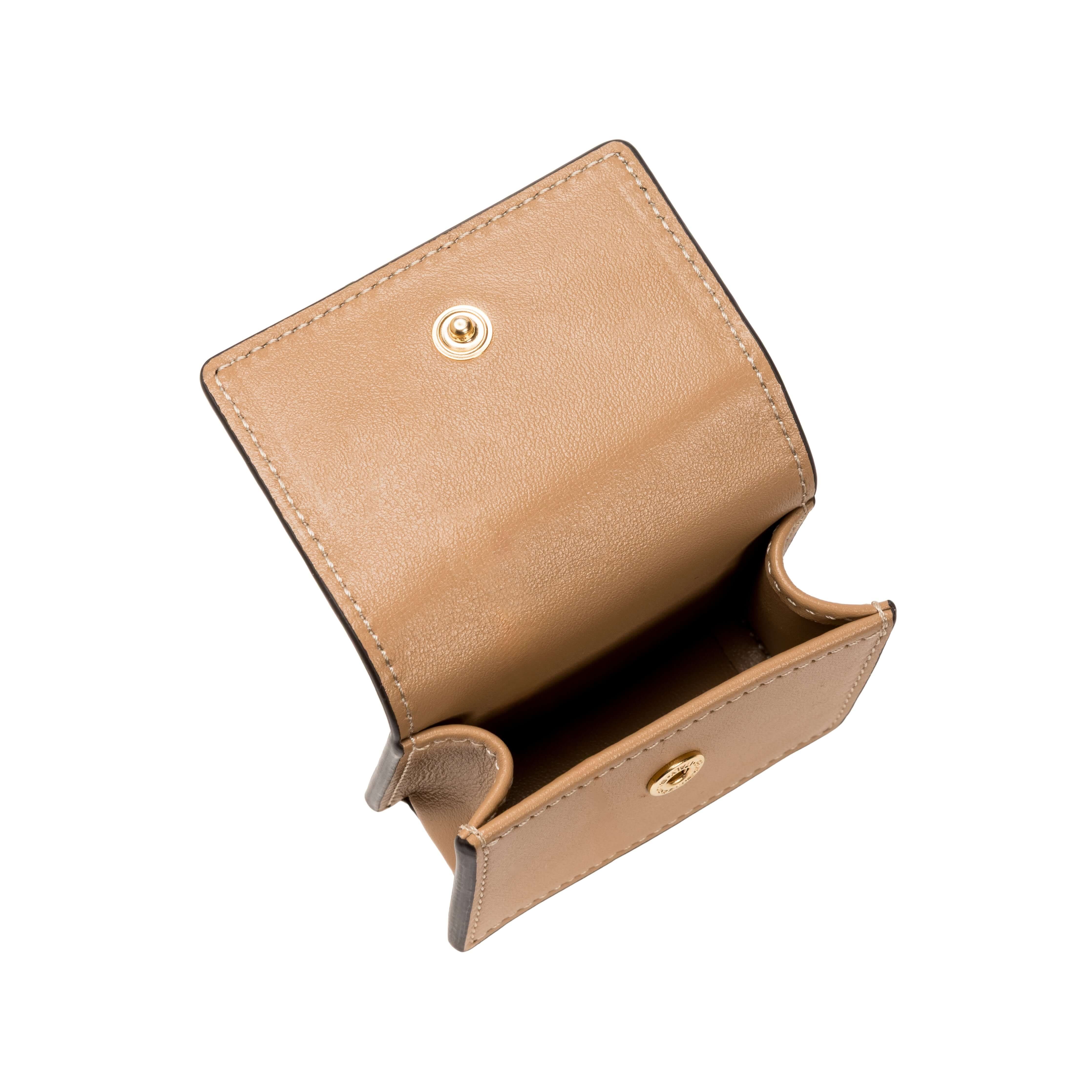 Open tan leather wallet with a snap closure, showcasing its interior compartments.