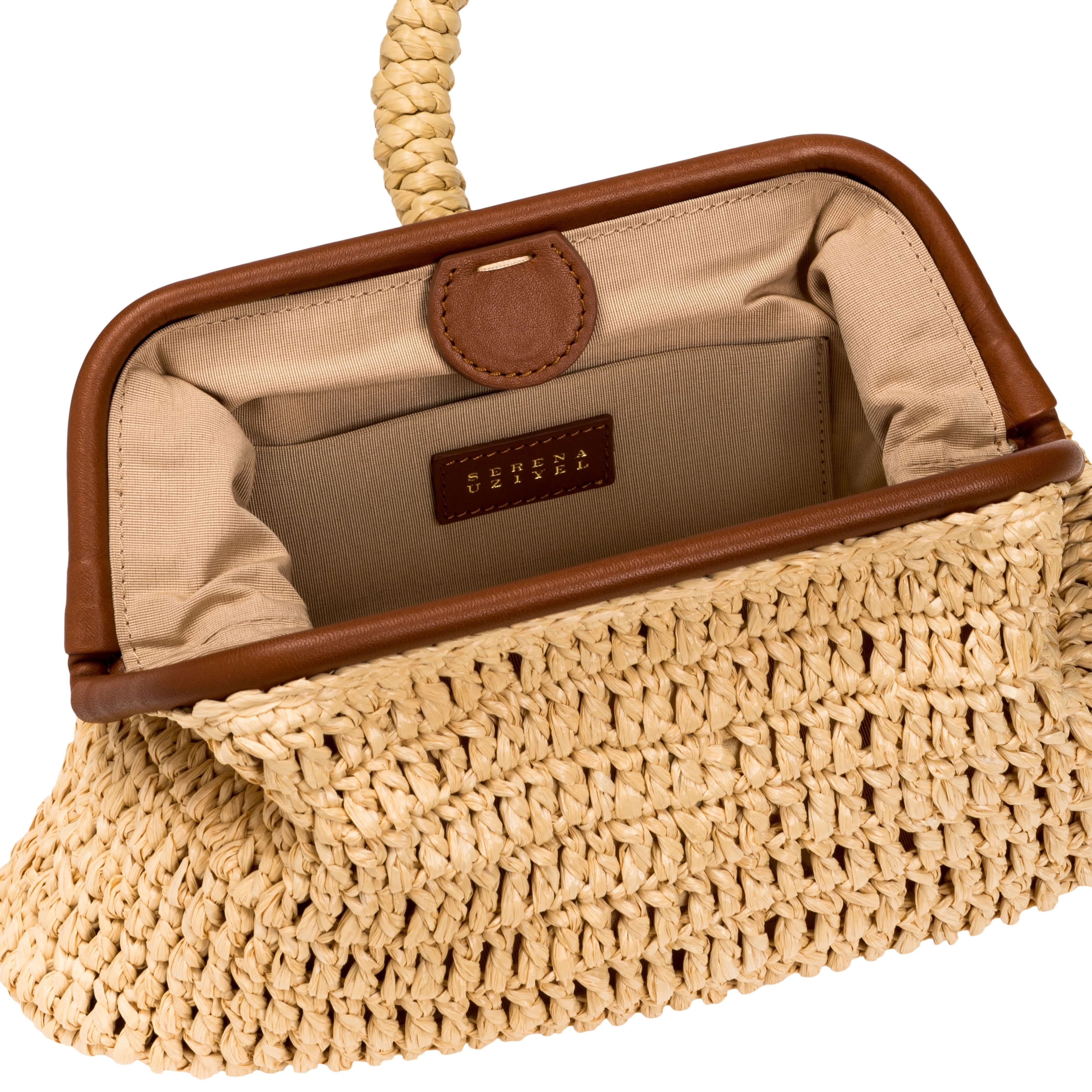 Interior view of Delphine Natural Pouch Bag, featuring beige raffia and a luxurious leather trim.