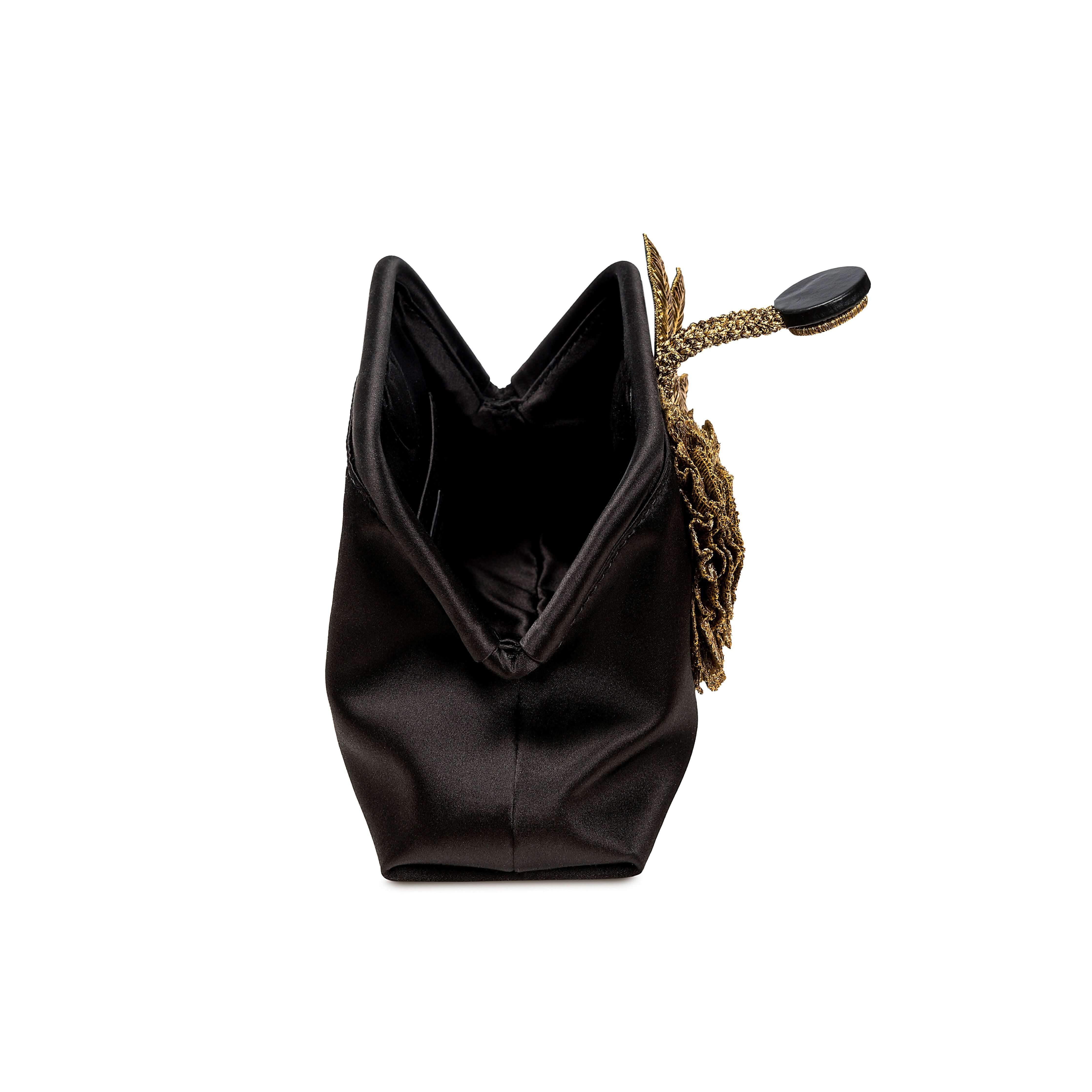 Elegant Fiora Black Pouch Bag showcasing a gold flower embellishment, perfect for evening events.