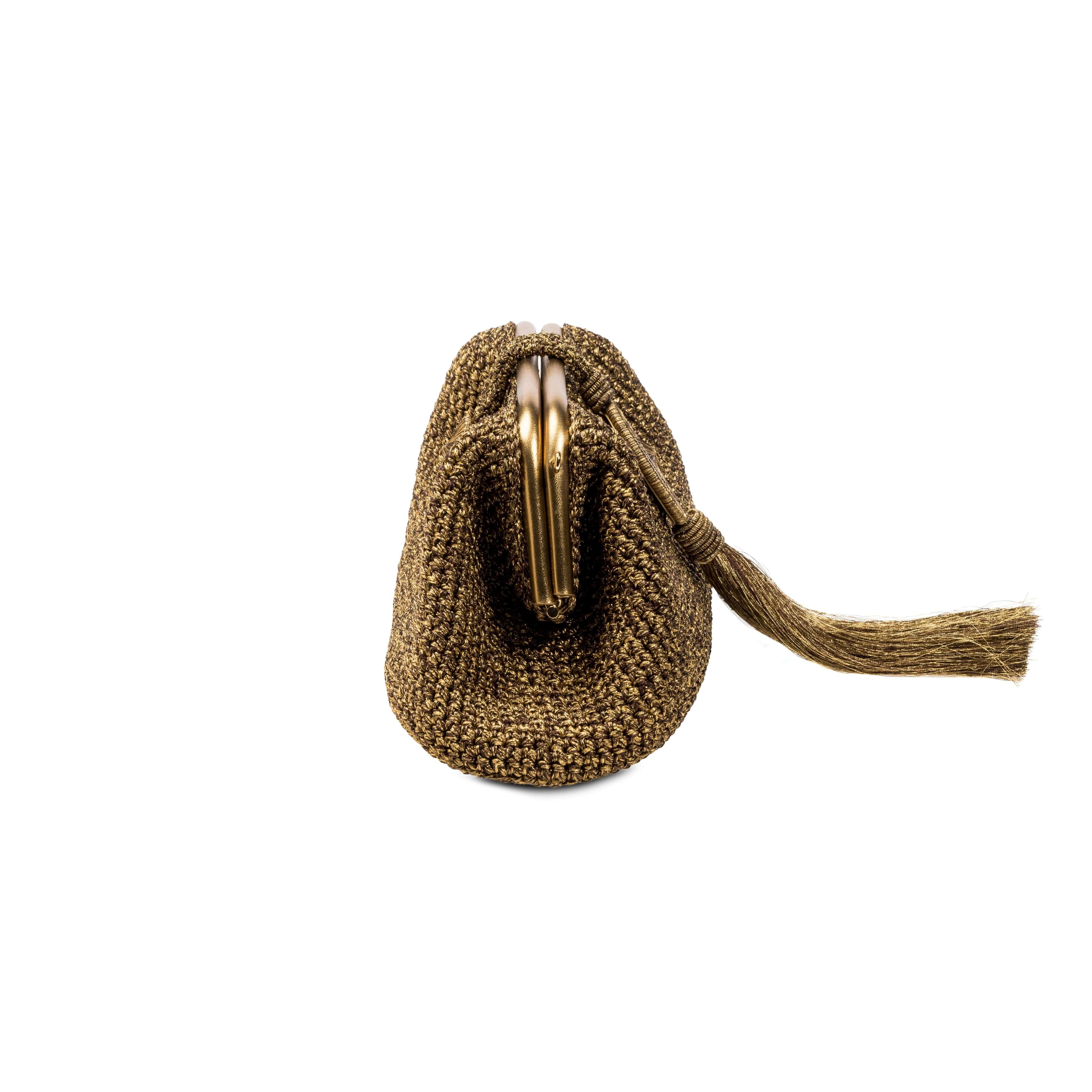Lia Pouch Bag in elegant gold-toned fabric, featuring a chic metal clasp and stylish tassel, perfect for any occasion.