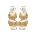 Rhea Gold 2 Knot Sandal featuring intricate knotted crochet straps and a comfortable block heel.