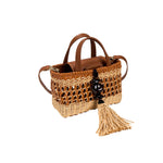 Almeria Camello Mini Tote Bag made of leather and straw with natural tones and a tassel accessory.