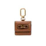 Catena Notte Camello AirPods case in brown leather with gold chain detail and keychain attachment.