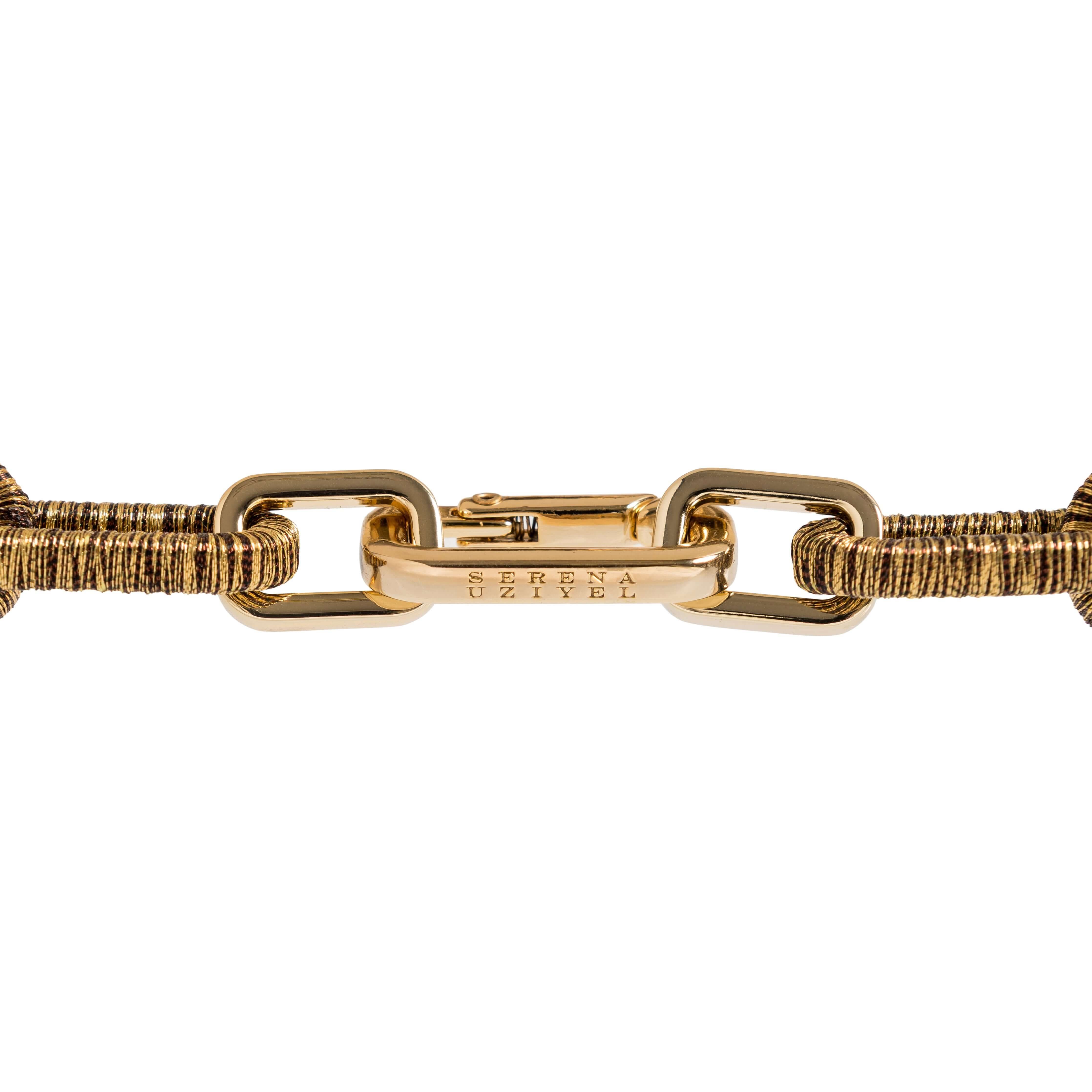 Catena rectangular necklace in antique gold, showcasing a secure clasp and intricate design details.