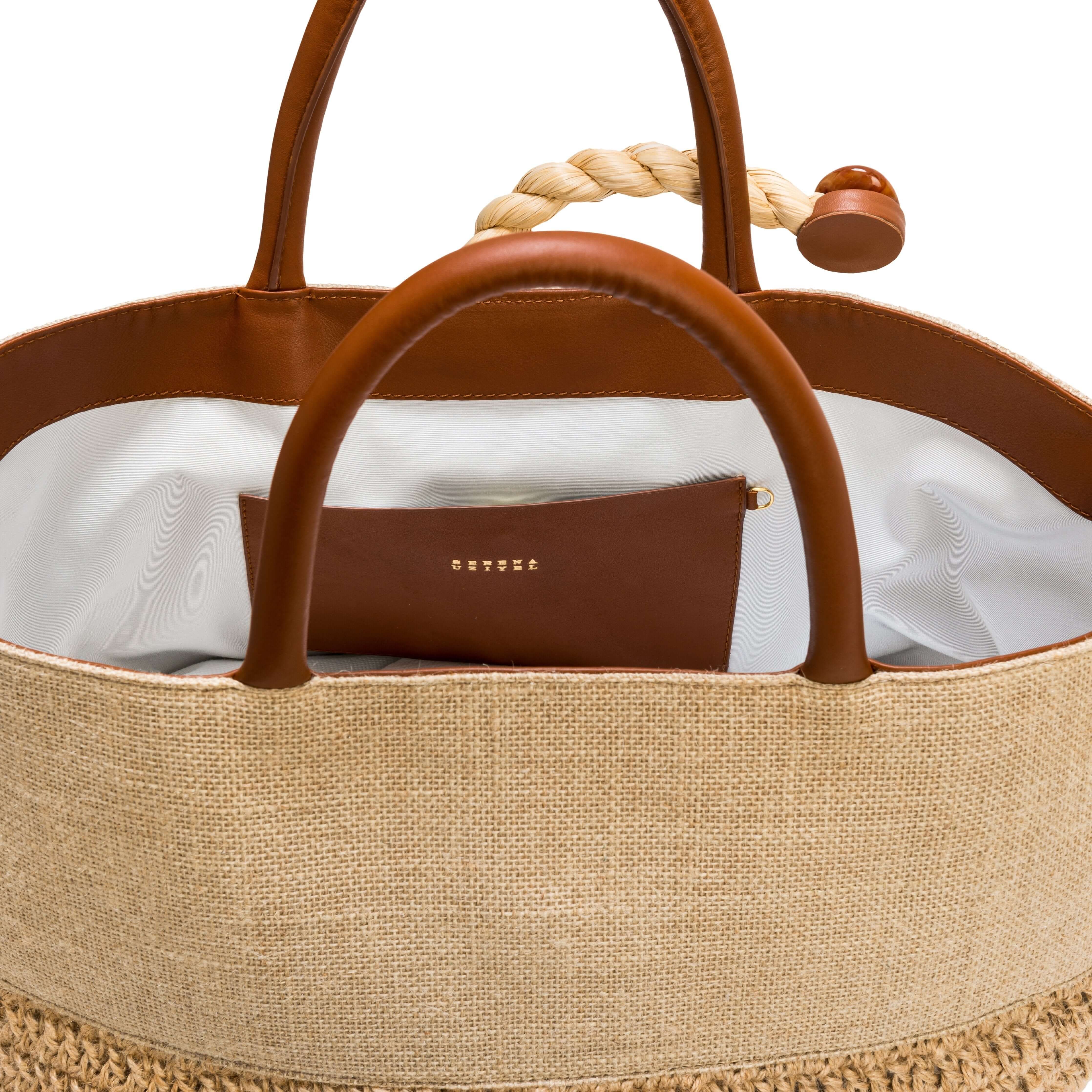 Interior view of Melita Natural Large Tote Bag featuring brown leather handles and a stylish design.
