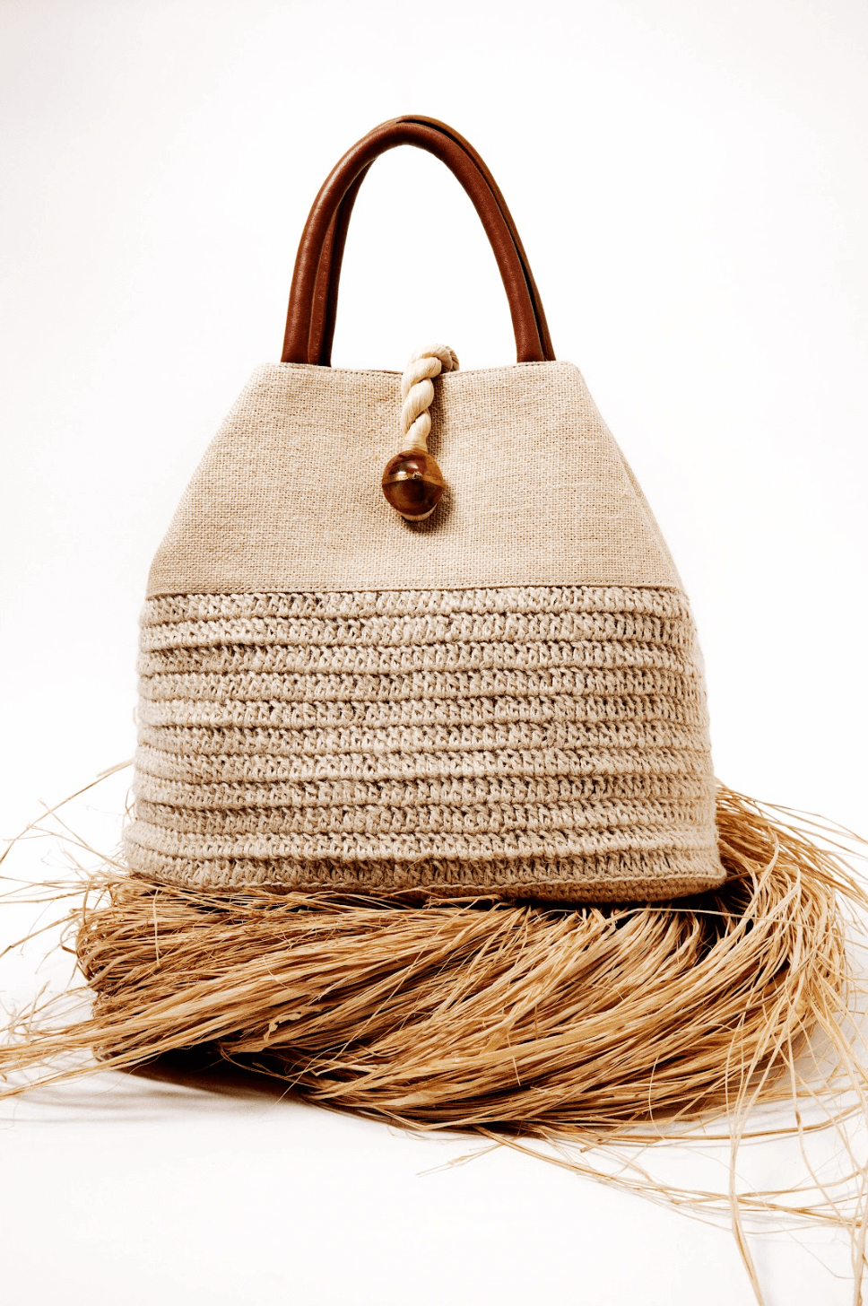 Elegant Melita Natural Large Tote Bag in woven raffia with silk tassel, perfect for summer style and retro-chic looks.