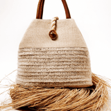 Elegant Melita Natural Large Tote Bag in woven raffia with silk tassel, perfect for summer style and retro-chic looks.